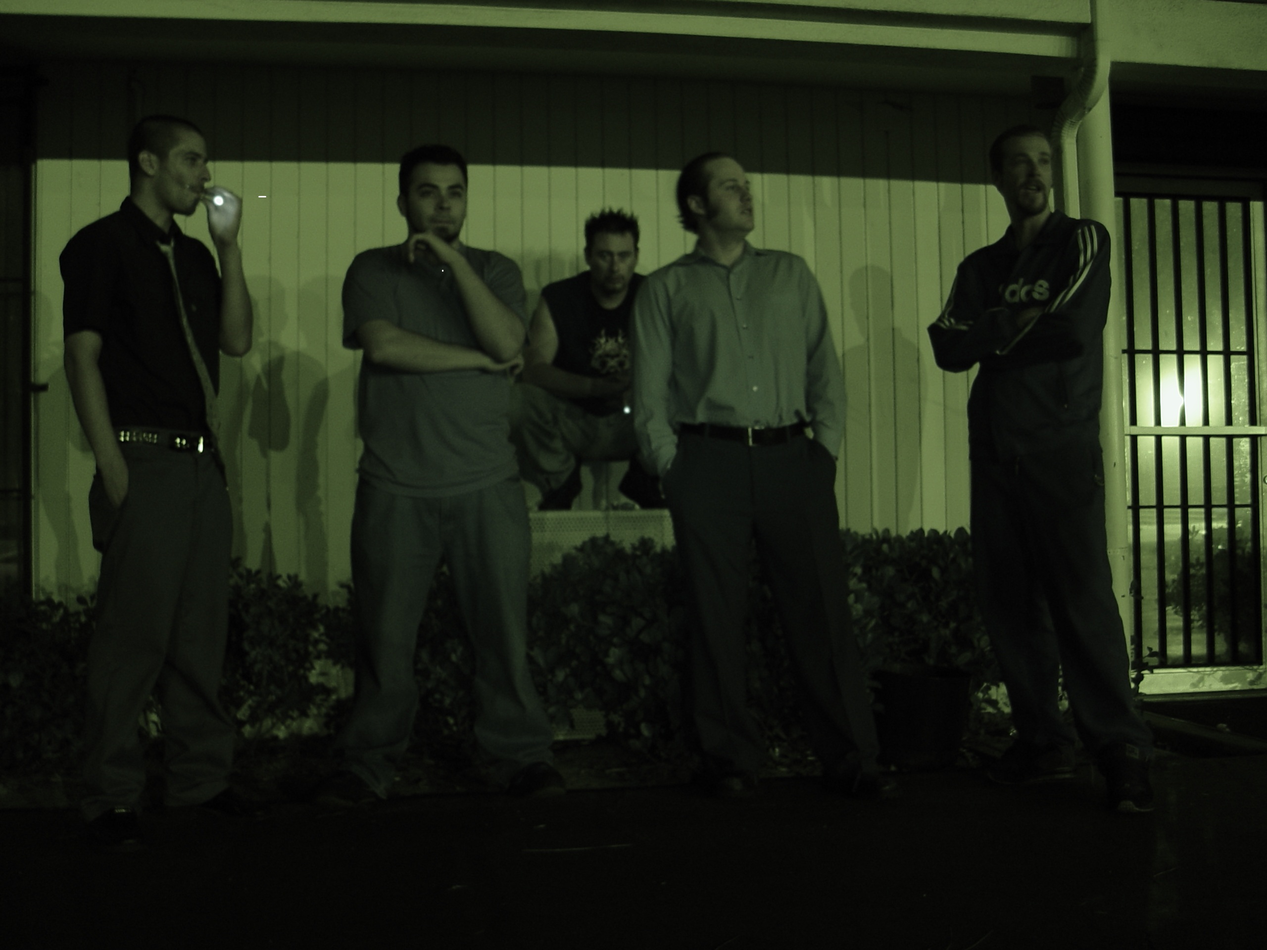 Band against a wall at night — green cast